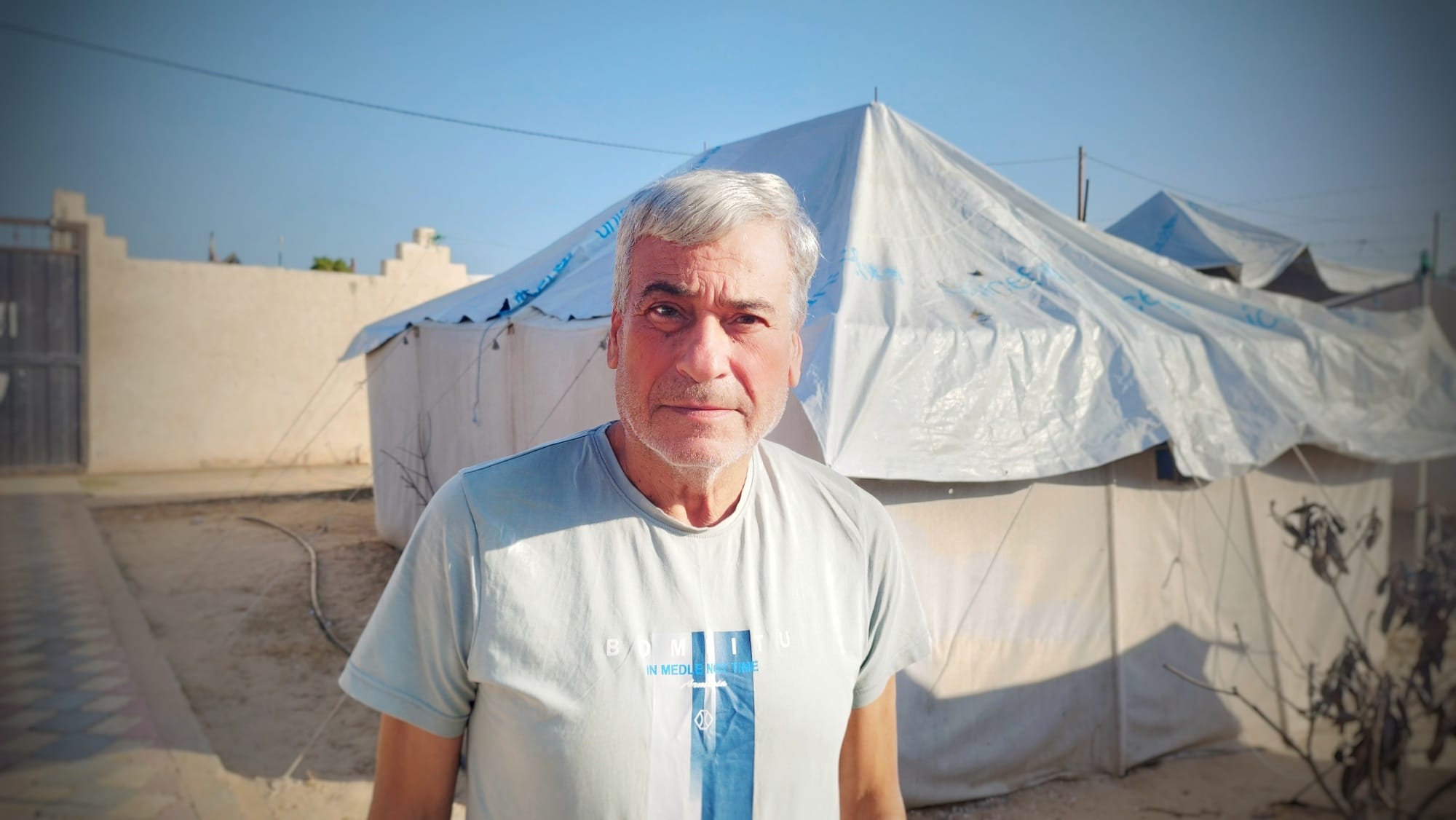عبد الكريم عاشور أمام خيمته في مراكز النزوح