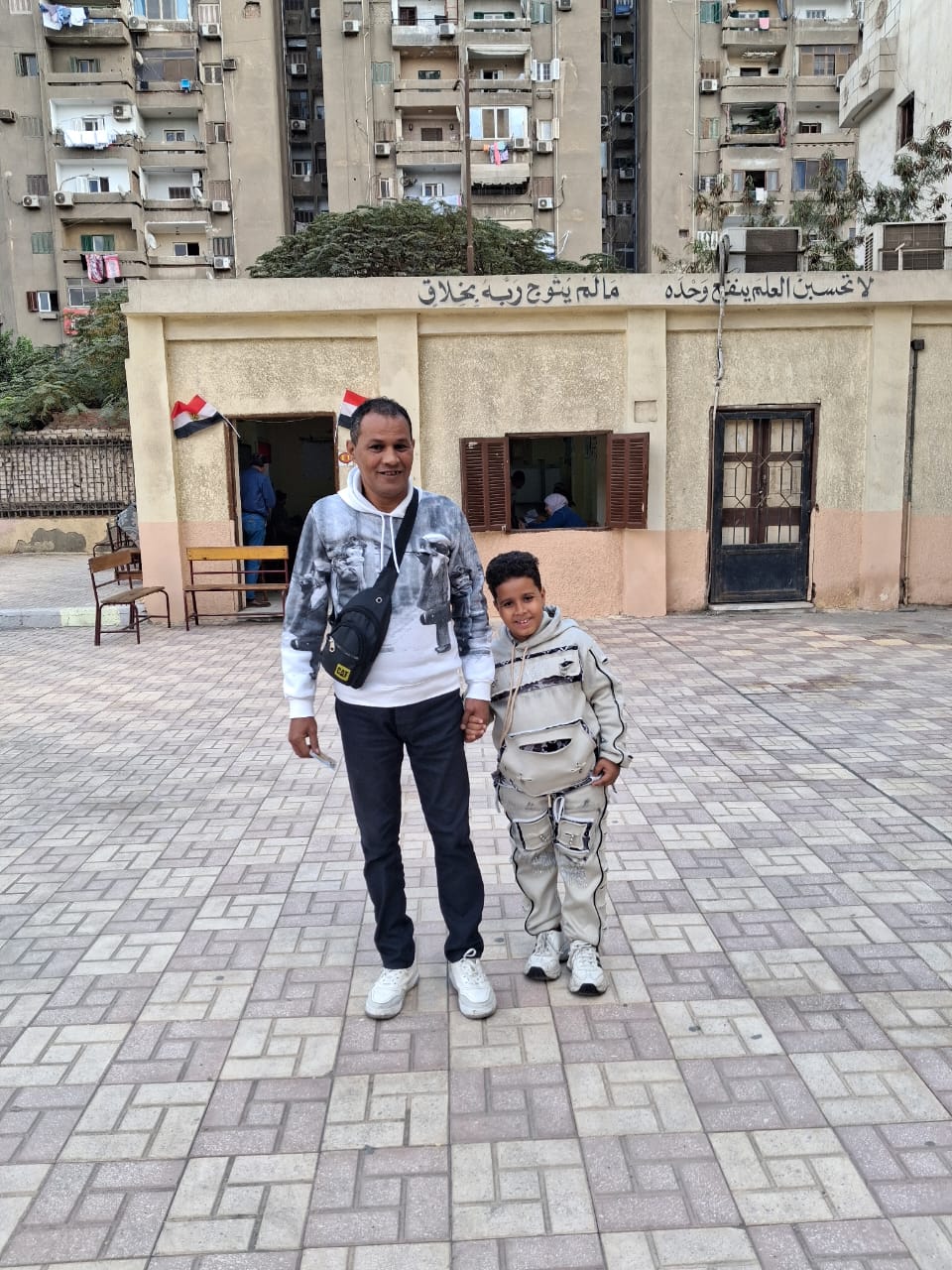  أب يصطحب نجله ليشهد معه لحظة التصويت فى انتخابات النواب