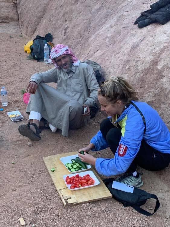 احدى السائحات مع الدليل البدوي أثناء طهى الطعام احدى السائحات مع الدليل البدوي أثناء طهى الطعام