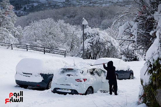 محاولات أزالة الثلج من على السيارات