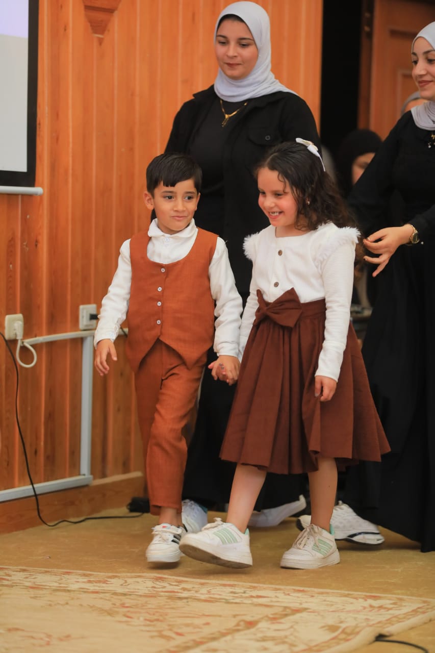 طفلان يرتديات ملابس صممتها الطالبات