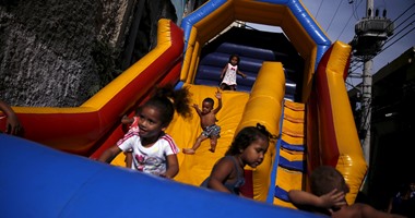 بالصور.. أطفال ريو دى جانيرو يلعبون بـ"نطاط القلعة" احتفالا بيومهم