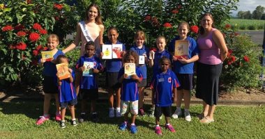 ملكة جمال استراليا توزع الكتب المدرسية على الطلاب فى بداية العام الدارسى
