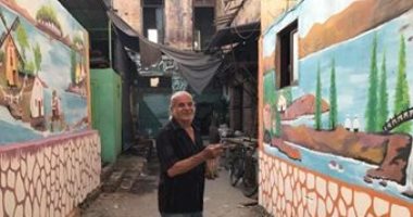 صور.. عم "على" يزين شوارع بورسعيد بلوحات وجداريات تحكى تاريخها
