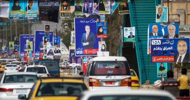 صور.. انتشار لافتات الدعاية الانتخابية فى مدينة النجف بالعراق