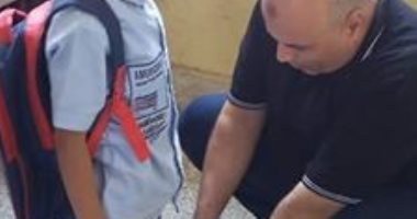 لقطة أبوية.. معلم يساعد تلميذه فى ربط الحذاء بسوهاج