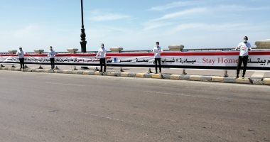 صور .. شباب يحملون علم مصر على كوبرى "ستنالى" ويرفعون شعار " خليك فى البيت"