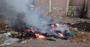 بالصور.. شكوى من حرق تلال القمامة أمام مدرسة إمبابة الثانوية العسكرية