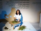 بالصور.. فنانة مصرية "تـخرط" الملوخية فى تجربة جديدة بصالون الشباب