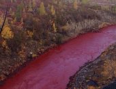 بالصور.. نهر روسى يتحول للون "الدماء"
