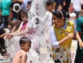 بالصور..  أطفال يحولون نافورة حديقة الأزهر لحمام سباحة فى عيد الفطر