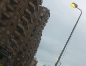 قارئ يرصد إضاءة أعمدة الكهرباء نهارا فى مدينة فيصل بالإسكندرية.. صور