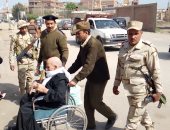 صور .. رجال الجيش يساعدون مُسن للإدلاء بصوته داخل لجنة بمنيا القمح