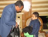 صور..وزير الداخلية يهدى طفل حقيبة ملابس رياضية عقب مشاركته بماراثون زايد