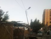 أهالى شارع سعد زغلول بكرداسة يشكون من أعمدة الإنارة المائلة