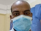 بالكمامة.. "محمد" يشارك بصورة خلال أداء عمله من محافظة أسوان 