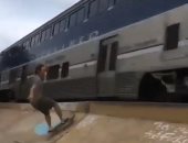 مغامران يتزلجان على السكة الحديد أثناء مرور قطار بأمريكا.. فيديو