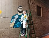  "نور" كرمت أبو جبل ومحمد صلاح بجرافيتى صورهم على جدران شوارع المرج