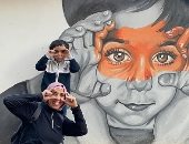 بالفرشاة والألوان .. "مها" رسمت الأطفال على جدران شوارع أسوان لنشر البهجة 