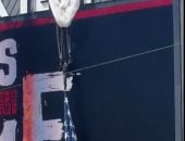 مظلى يعلق بشاشة عرض فى ملعب أمريكى قبل مباراة جامعية.. فيديو