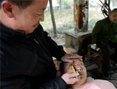 بالصور.. حلاق صينى ينظف مقلة العين "بالشفرة" على الطريقة الصينية