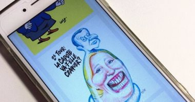 بالصور.. شارلى إيبدو تجسد ماكرون فى هيئة "واقى ذكرى" على رأس لوبان