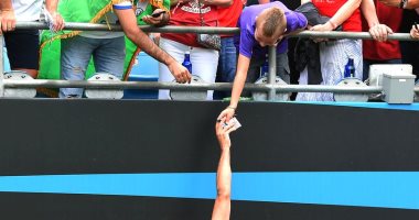 محمد صلاح يلبى طلب طفل صغير للحصول على توقيعه من دكة بدلاء ليفربول.. صور