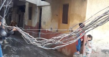 صور.. أهالى قرية أبيس بالإسكندرية يستغيثون من كابلات الكهرباء بالشوارع