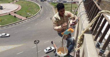 صور.. رفع كفاءة ميدان التحرير ودهان العقارات المحيطة