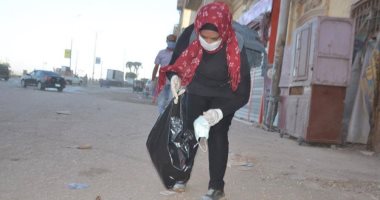 صور.. فتاة أقصرية تجمع الكمامات المستعملة من الشوارع لحماية الأهالى