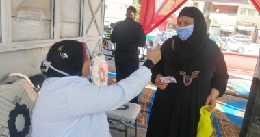 قياس حرارة الناخبين المتواجدين أمام لجان انتخابات مجلس النواب بالفيوم.. صور