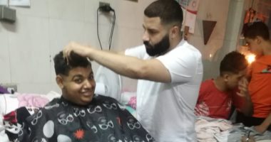 "حلاق" يرسم البهجة على وجه مرضى مستشفى جامعة طنطا بتصفيف شعرهم مجانا