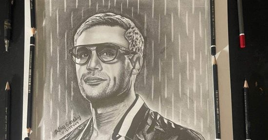 يحلم بالعالمية.. "فتحى" يرسم بالرمل الأسود لإخراج لوحة فنية مجسمه