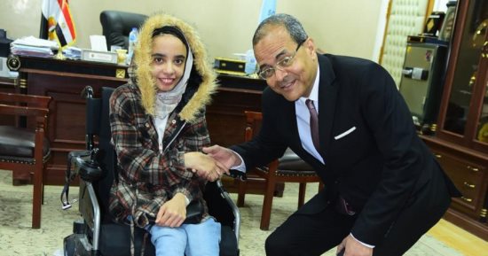 جامعة سوهاج تهدى طالبة من ذوى الهمم كرسيا كهربائيا متحركا