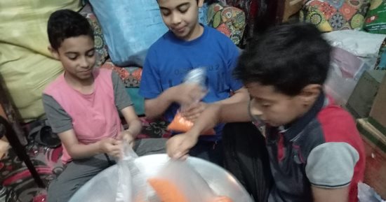 أطفال قرى إسنا يشاركون فى تجهيز شنط رمضان لتوزيعها على الأهالى.. صور