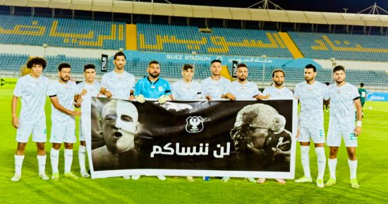لاعبو المصرى يلتقطون صورة تذكارية مع لافتة وفاء للراحل ميمى عبد الرازق