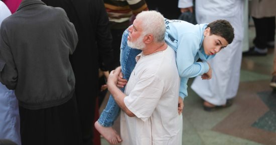 الجد السند.. جد يحمل حفيده من ذوي الهمم بصلاة العيد فى مسجد عمرو بن العاص