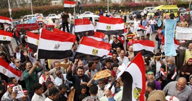 متظاهرو المنصة يوزعون صوراً لعمر سليمان والسادات