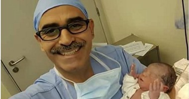 طبيب يلتقط صورة لطفل مولود ساعة الإفطار رافعًا يديه للسماء
