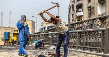 "مين اللى محنى لك عمار".. عاملون يتحدون حرارة الطقس ويرممون كوبرى الجيزة